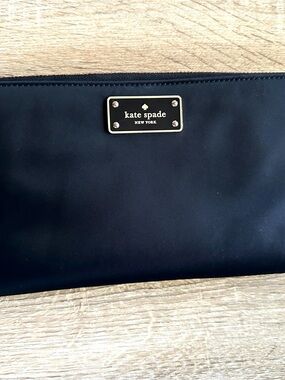 Kate Spade black wristlet clutch with gold plaque